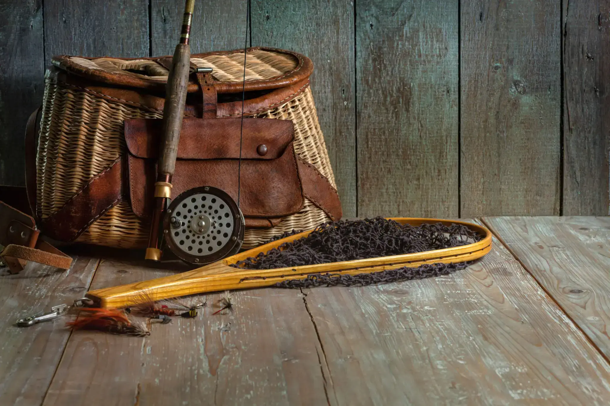 Traditional fishing gear including a net and a leather bag.