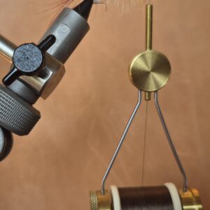 Close-up of a precision measuring instrument with a dial and metal arms.