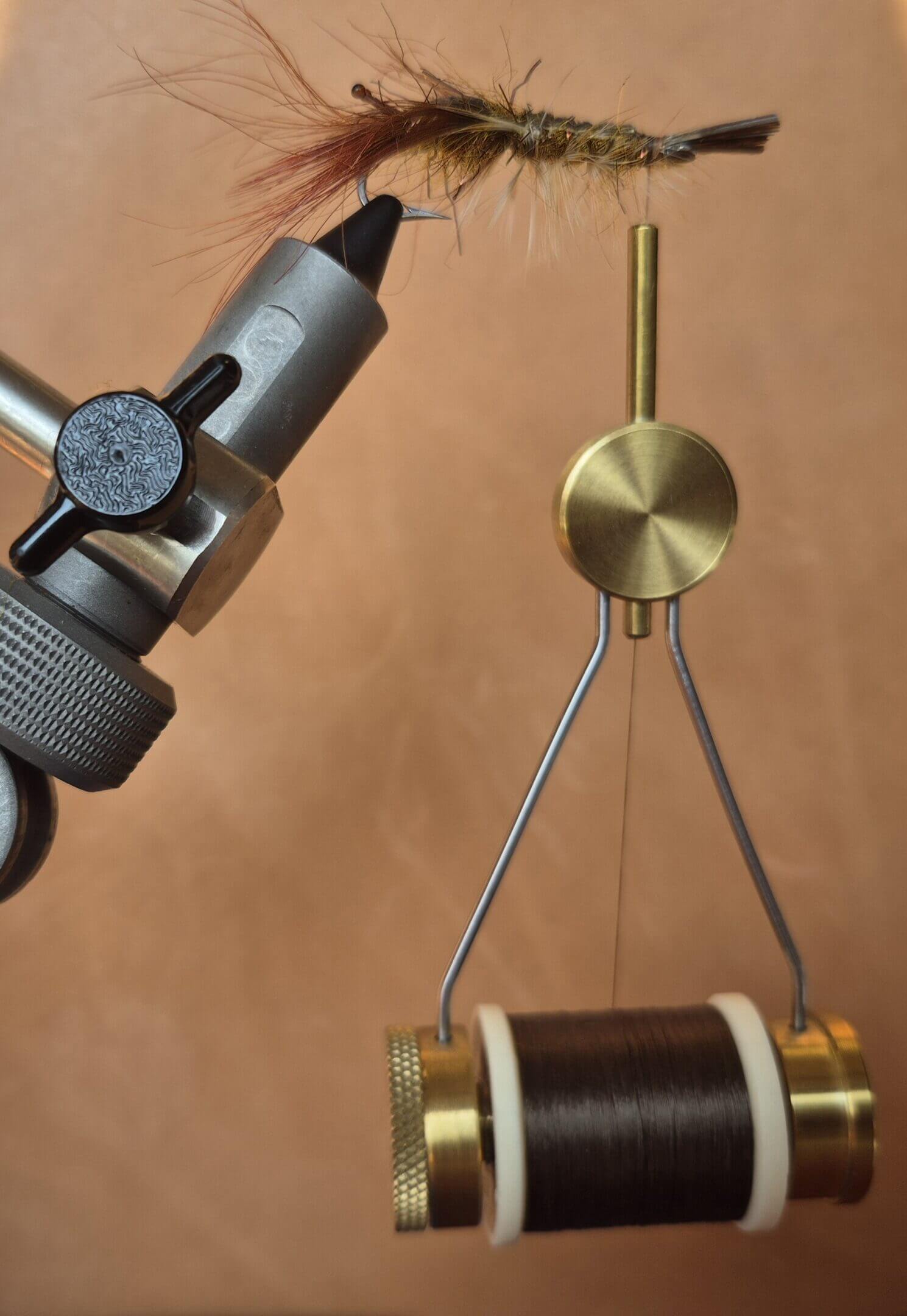 Close-up of a precision measuring instrument with a dial and metal arms.
