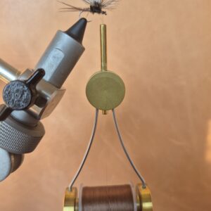 Close-up of a mechanical device with a dial and wire components.