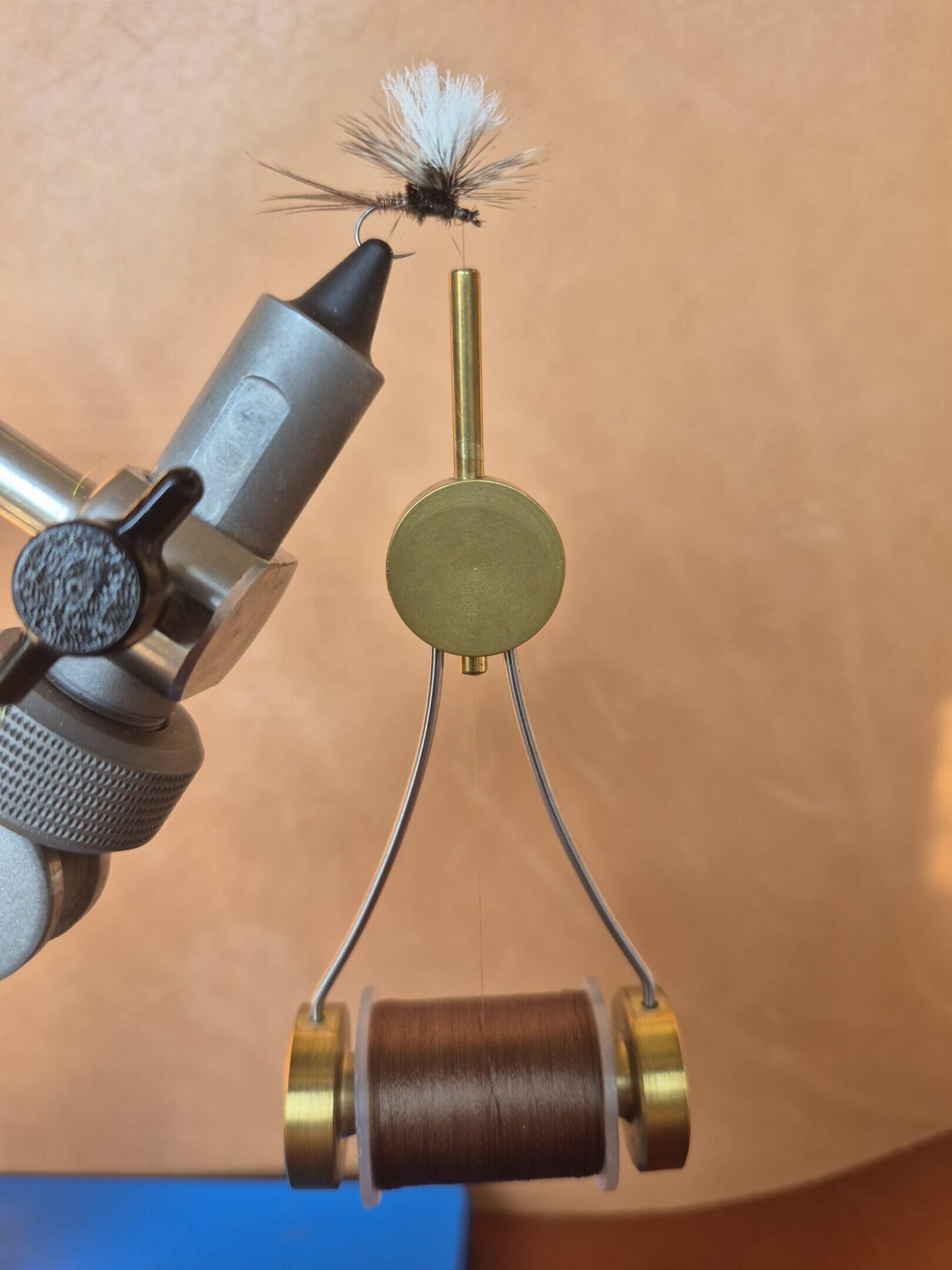 Close-up of a mechanical device with a dial and wire components.